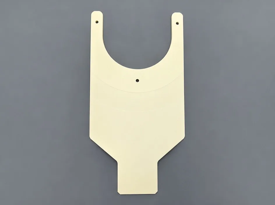A white alumina fork plate with a wide rounded yoke and a single central hole, on a grey studio ground.