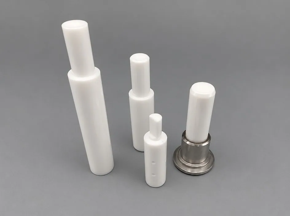 Four white stepped plungers of different sizes on a grey studio ground, the smallest seated in a short metal cup.