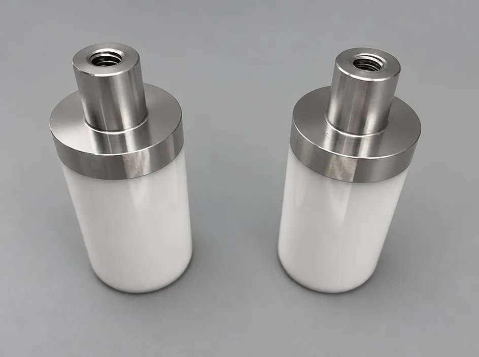 Two white cylinders on a grey studio ground, each fitted with a machined metal top carrying a threaded bore.