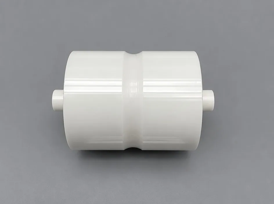 A white cylinder on a grey studio ground with a machined waist groove around its middle and a short pin at each end.