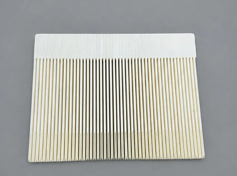 A single white plate on a grey studio ground, one half solid and the other cut into a dense row of fine parallel ribs.