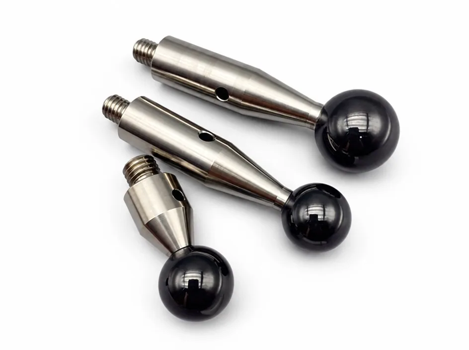 Three assemblies on a white ground, each pairing a silicon nitride ball with a machined metal shaft and a threaded end.