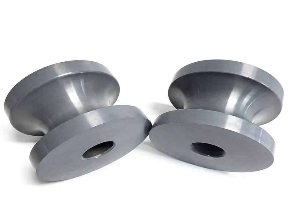 Four silicon nitride discs on a white ground, each with a wide flange, a hub and a central bore.