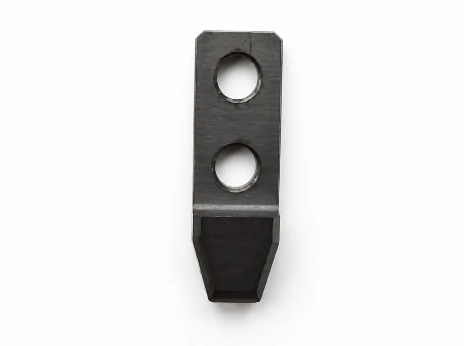 A silicon nitride bar on a white ground with two large bores through the flat section and a tapered tongue at one end.