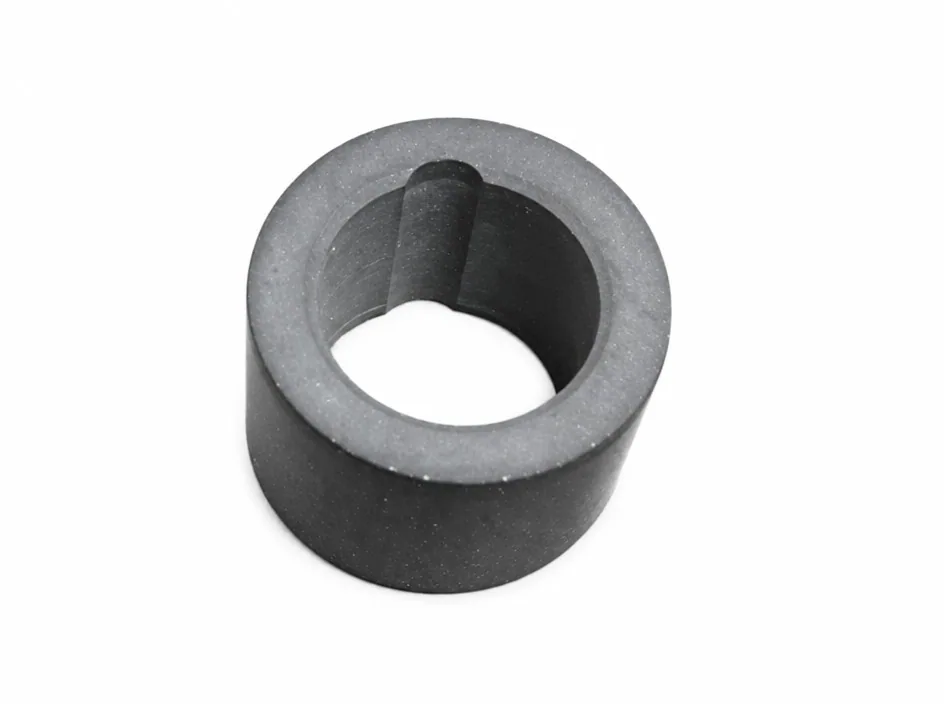 A thick-walled silicon nitride bush on a white ground, with a raised rib running down the inside of the bore.