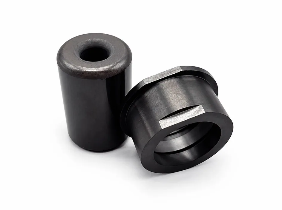 Two silicon nitride bushes on a white ground, each with a rectangular keyway cut across the bore.
