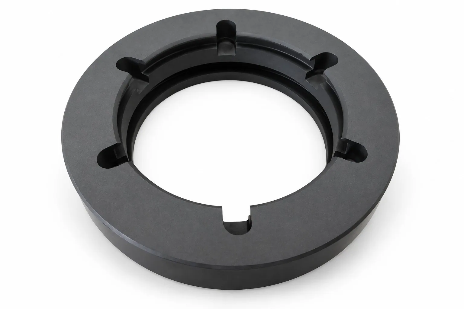 A wide black silicon carbide ring on a white ground with five raised rectangular lugs spaced around the inner bore.